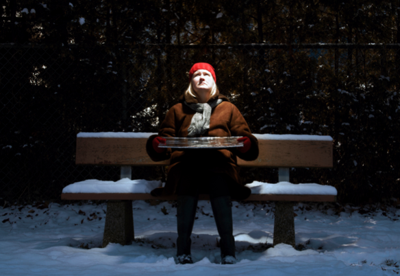 sad woman on bench trying to get sun for SAD